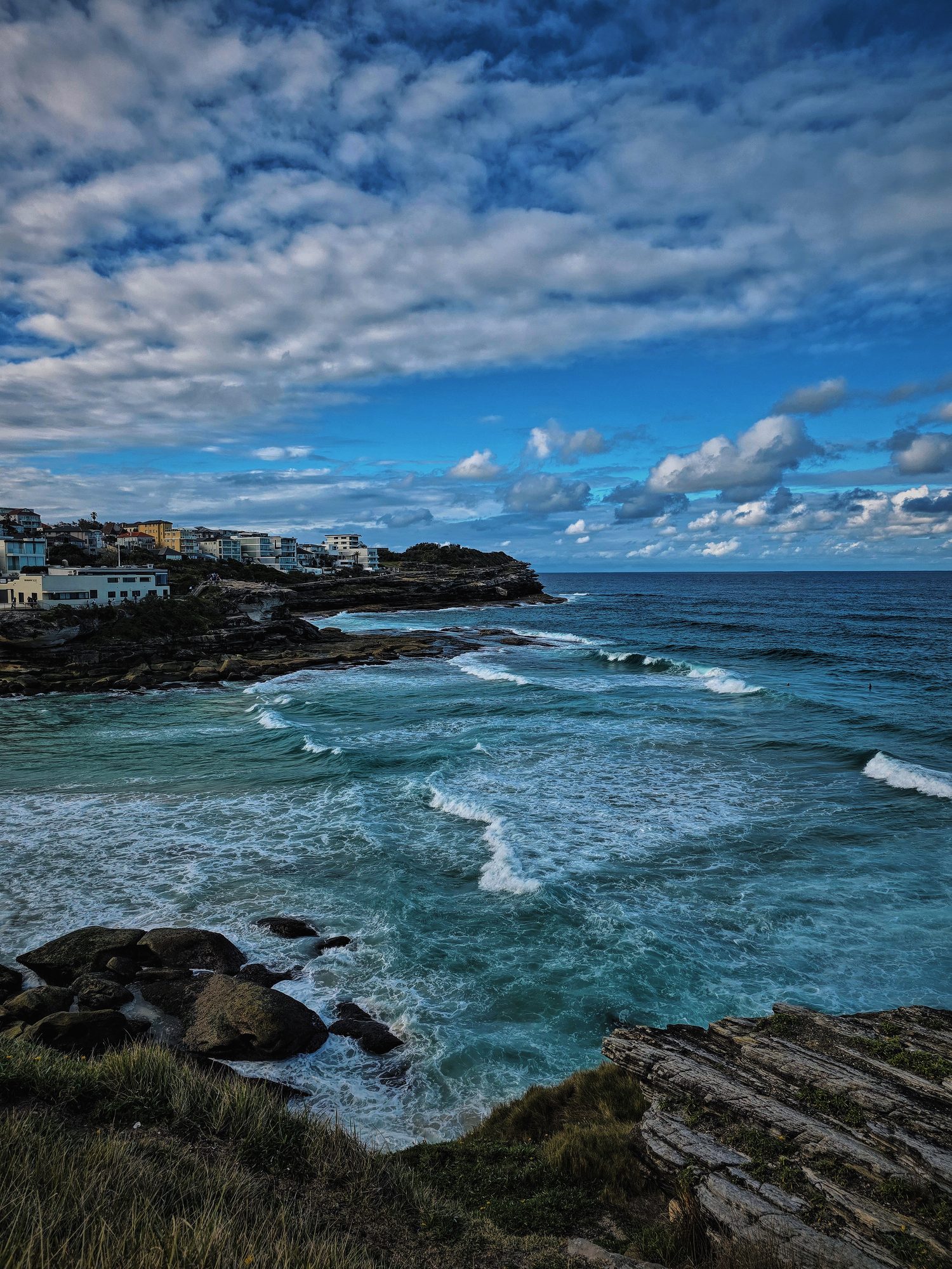 Coastal walk, surf rolling in past the headland.