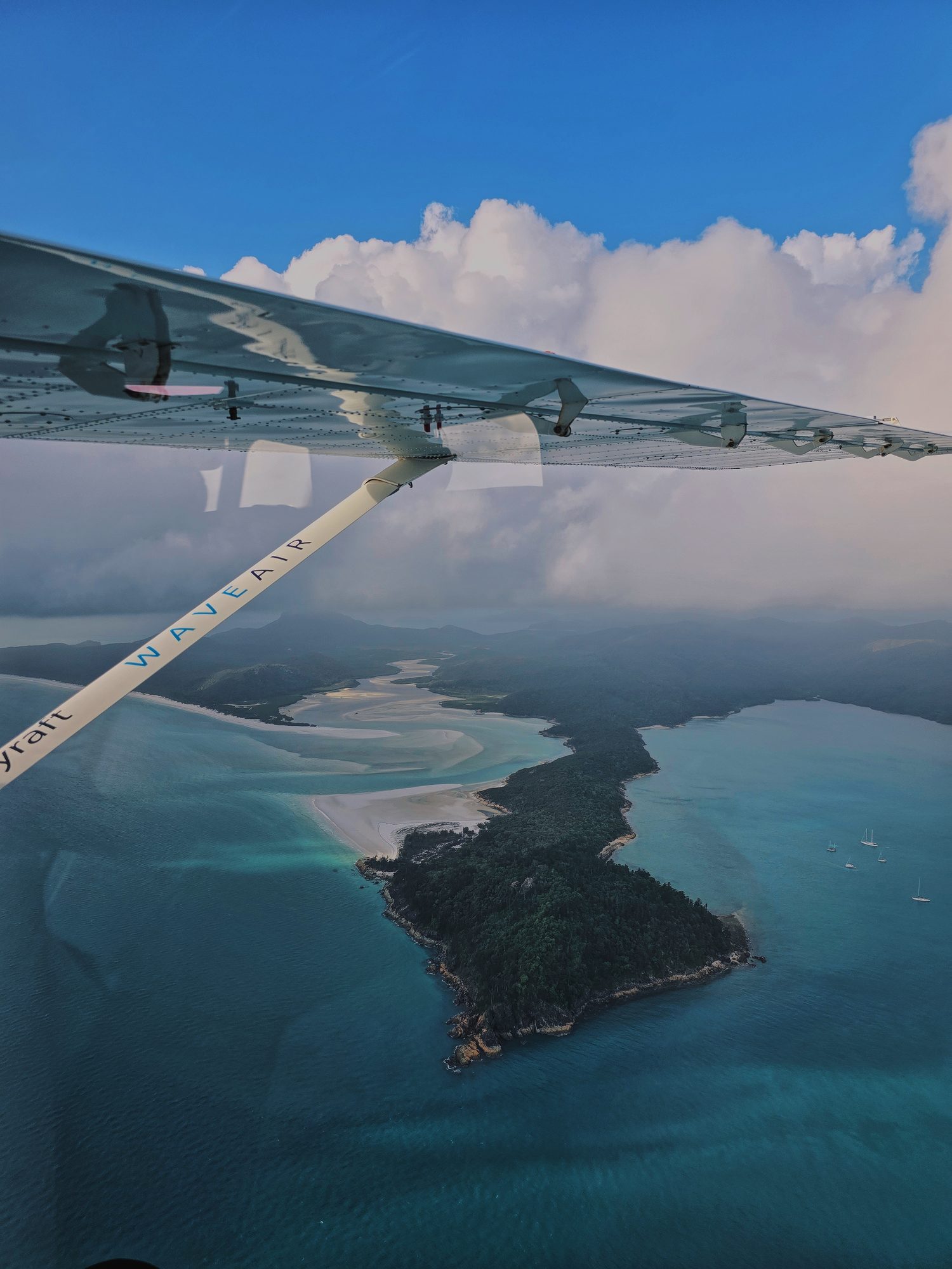 Wing over the Whitsundays, an hour into the flight.