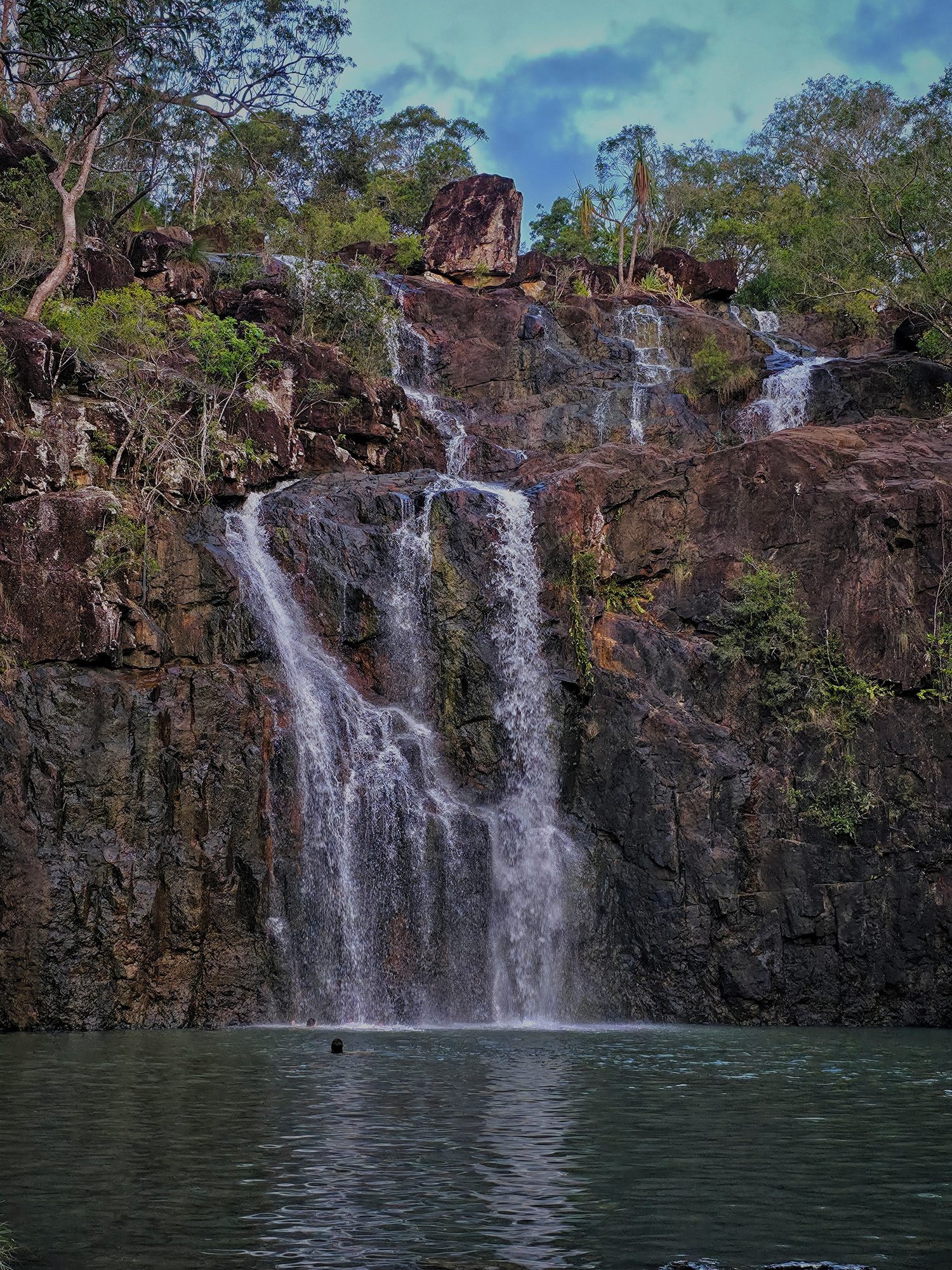 Falls into a quiet pool, sound of water and nothing else.